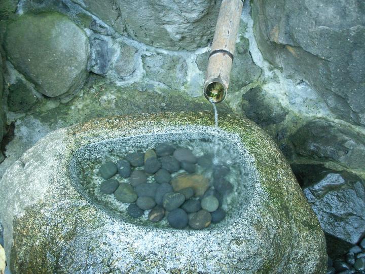 fountain dripping into rock pool with smalll rocks
